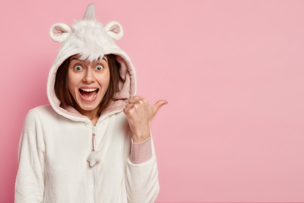 Young woman wearing unicorn pajamas