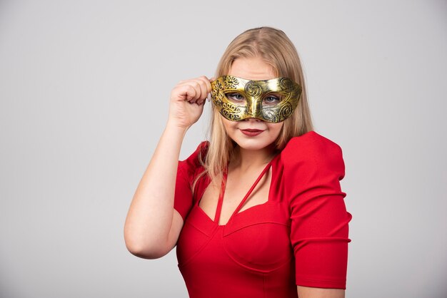 Young woman wearing a venetian carnival mask