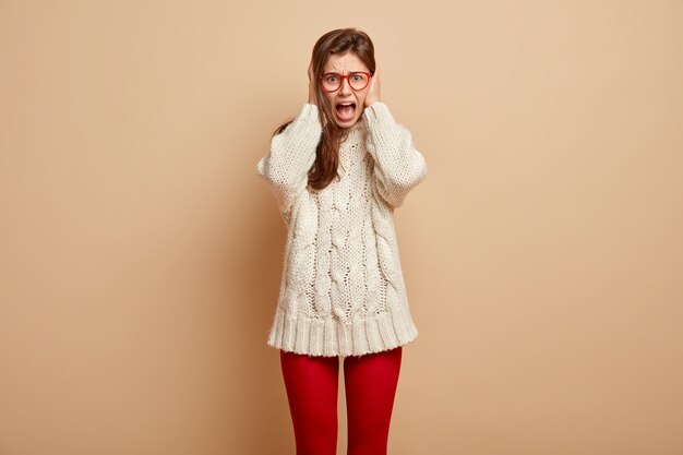 Young woman wearing white sweater