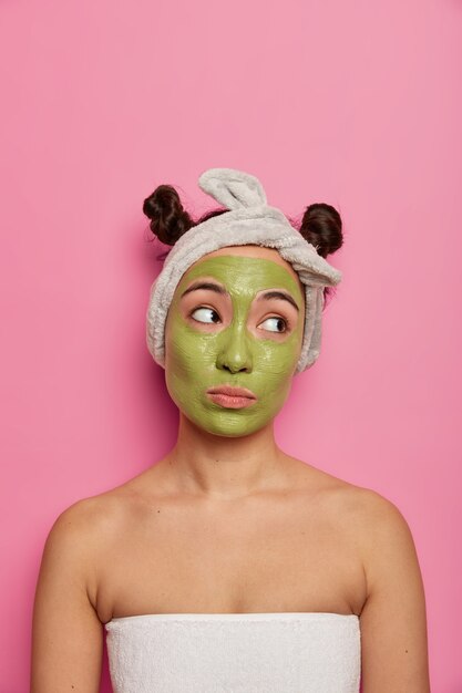 Young woman wears natural facial mask skin treatments after taking bath