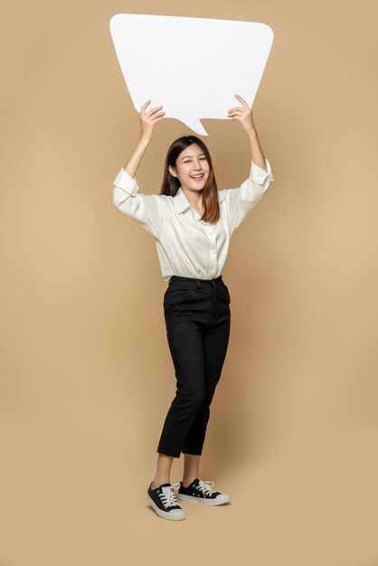 A young woman in a white shirt holding a thought box symbol