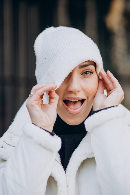 Free Photo young woman in winter hat standing outdoors