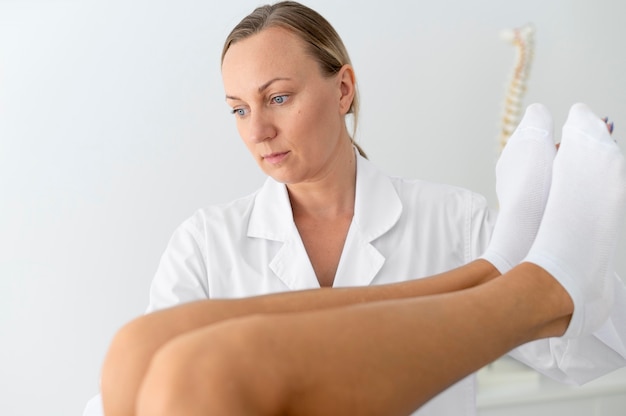 Young woman with back problems doing a physiotherapy treatment