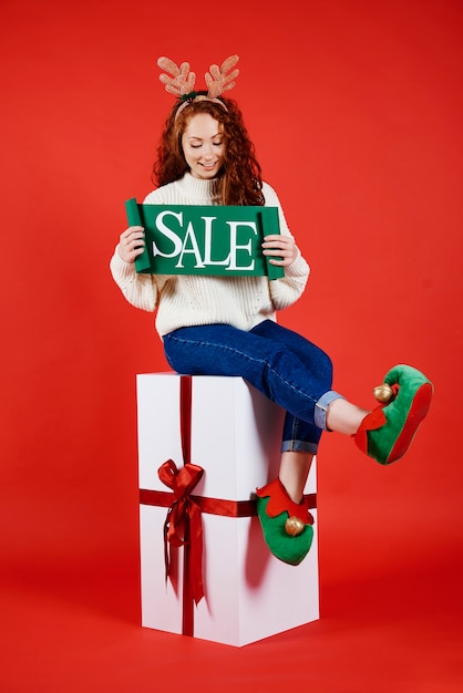 Free Photo young woman with banner of winter sale