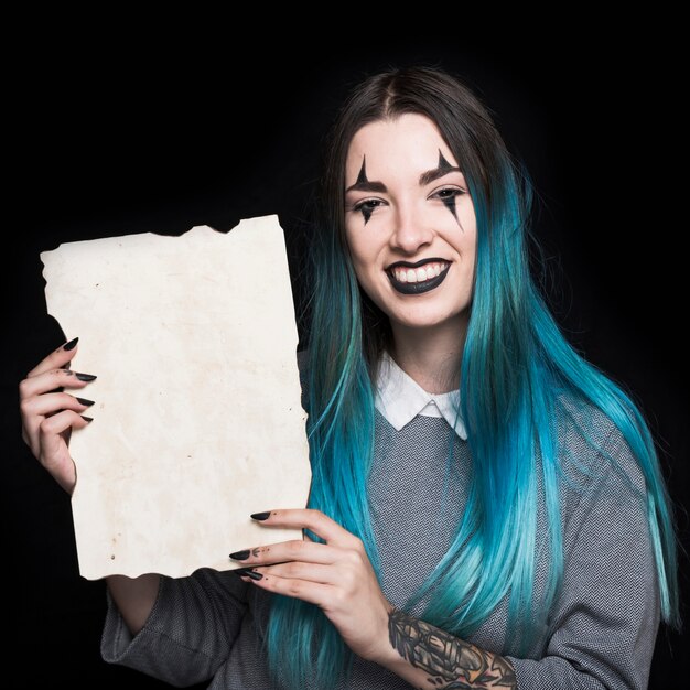 Young woman with blue hair holding paper