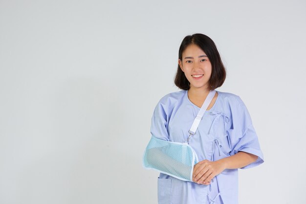 Young woman with a broken arm wearing an arm splint