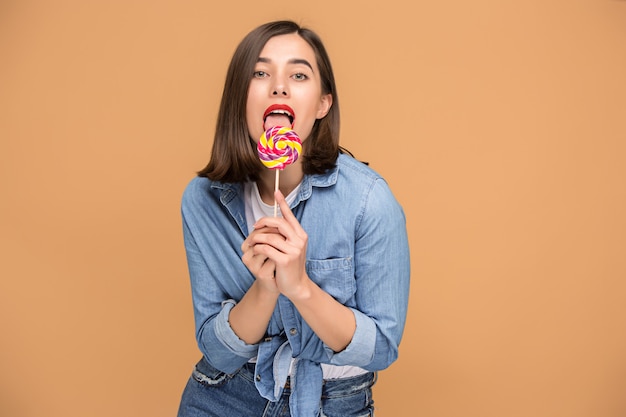 Free photo the young woman with colorful lollipop