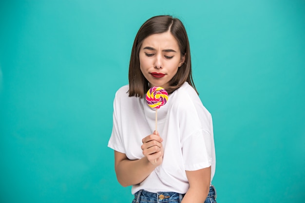 Free photo the young woman with colorful lollipop