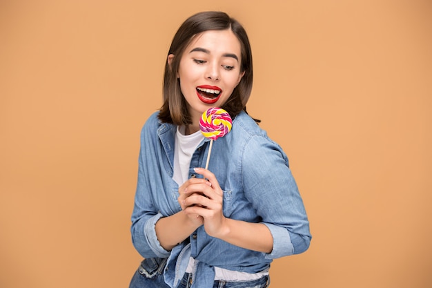 The young woman with colorful lollipop