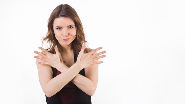 Free Photo young woman with crossed hands smirking