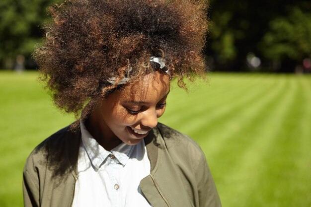 Young woman with curly hair wearing bandana