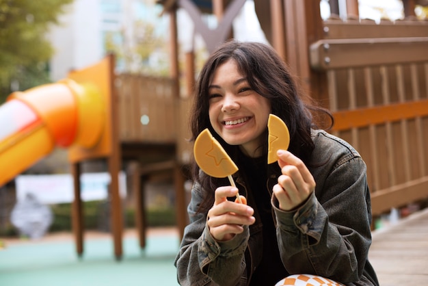 Young woman with dalgona cookie