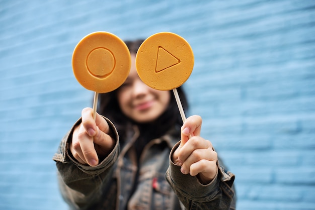 Free photo young woman with dalgona cookie