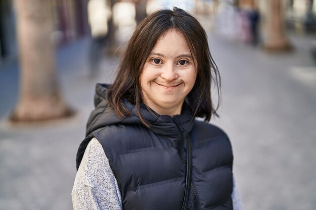 Young woman with down syndrome smiling confident standing at street