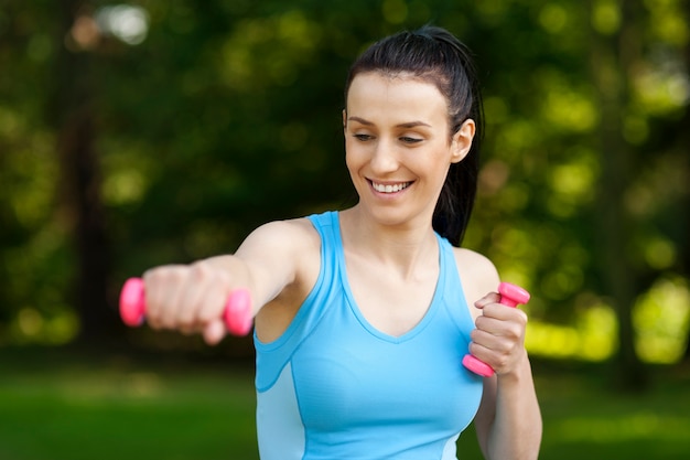 Young woman with dumbbells