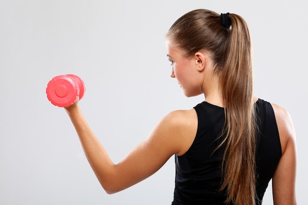 Young woman with dumbells