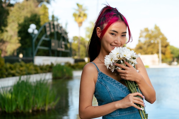 Young woman with dyed hair near lake