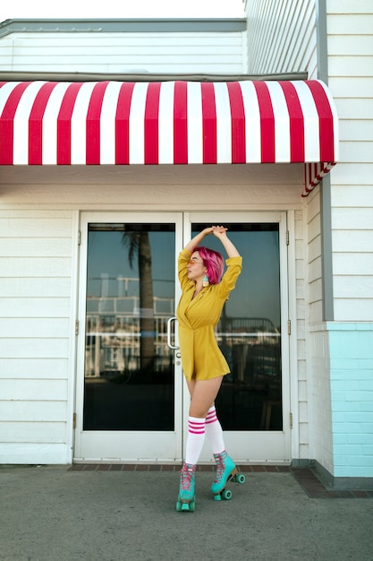 Young woman with dyed hair near shop