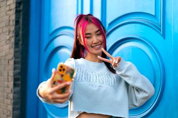 Young woman with dyed hair taking a selfie