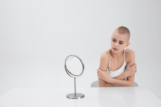 Young woman with an eating disorder checking herself in the mirror