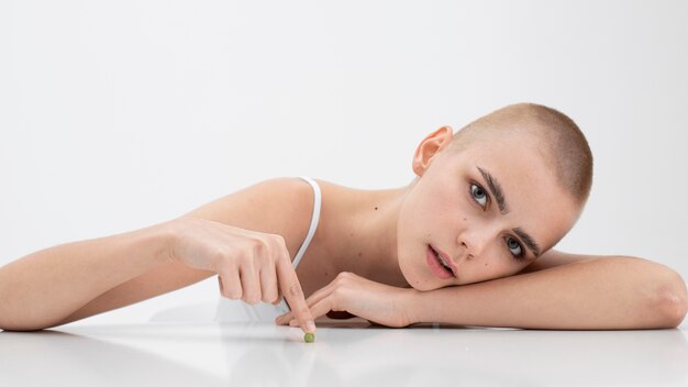 Young woman with an eating disorder wanting to eat a pea