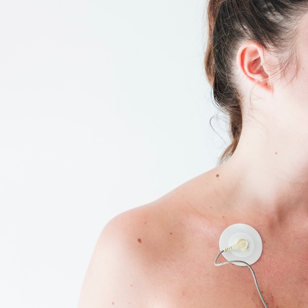 Young woman with electrode on body