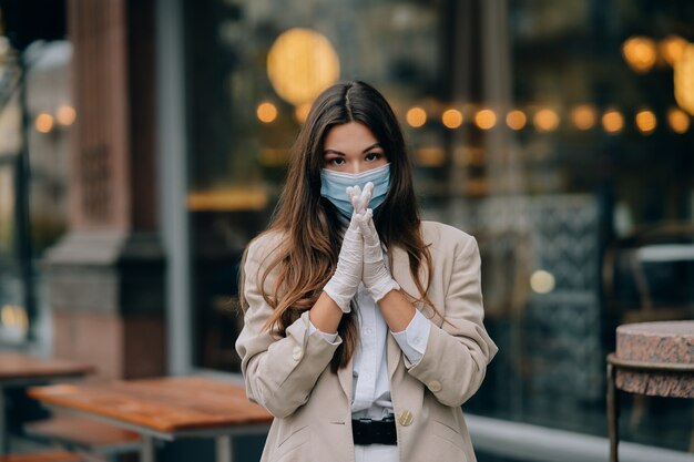 Young woman with face mask in the street