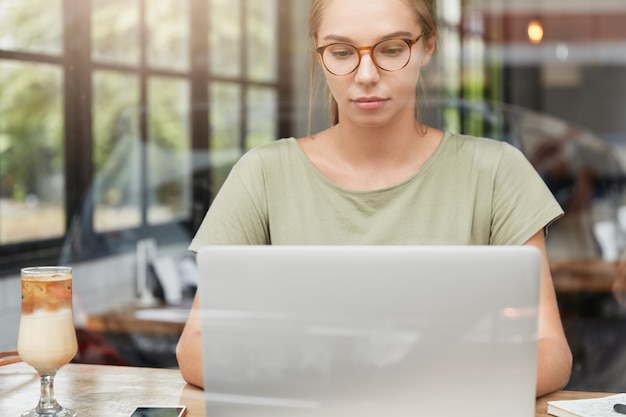 Young woman with glasses in cafe