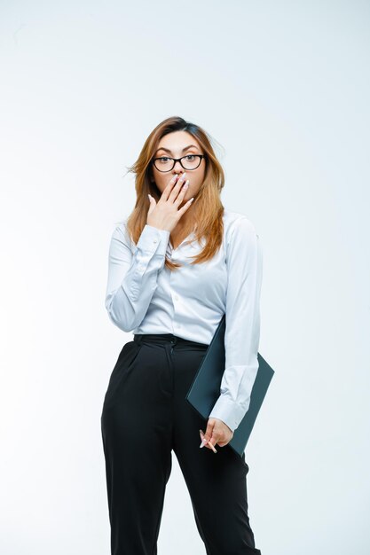 Young woman with glasses looking amazed