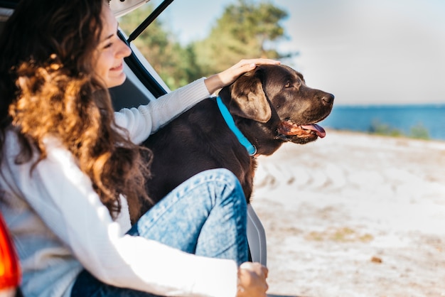 Young woman with her dog at the beach