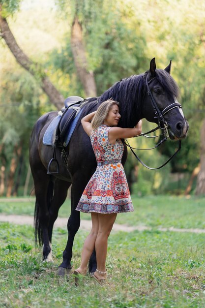 Young woman with a horse