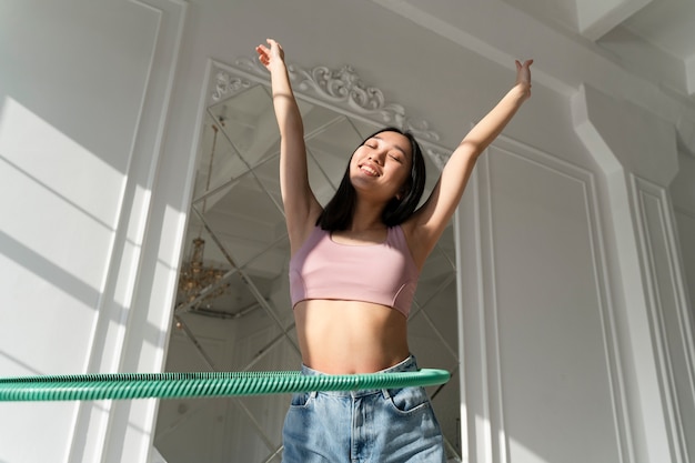 Young woman with hula hoop