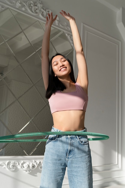 Young woman with hula hoop