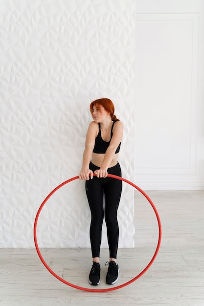 Young woman with hula hoop