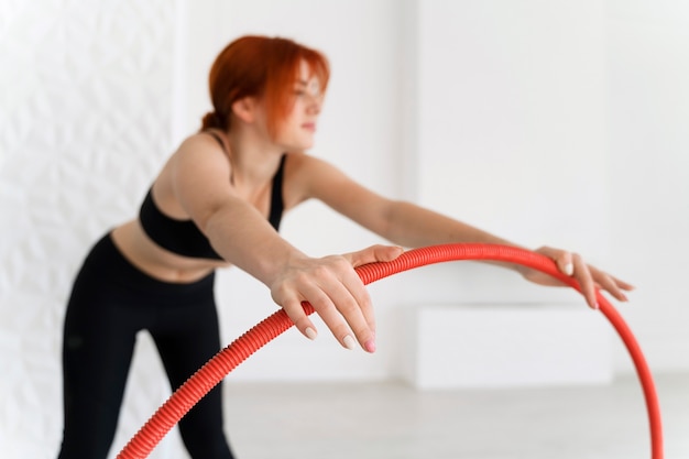 Young woman with hula hoop