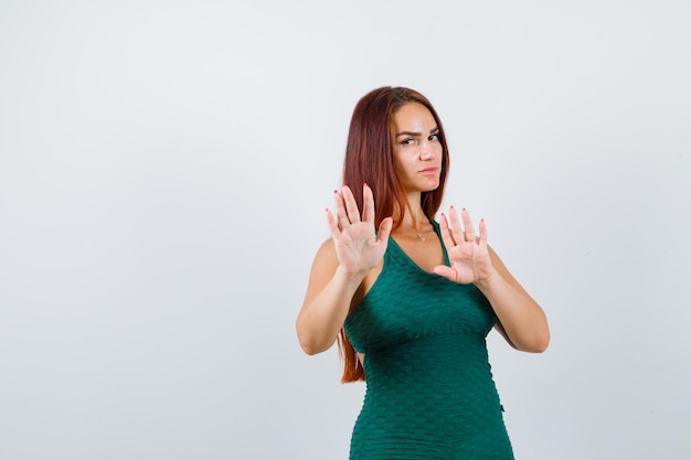 Young woman with long hair in a green bodycon