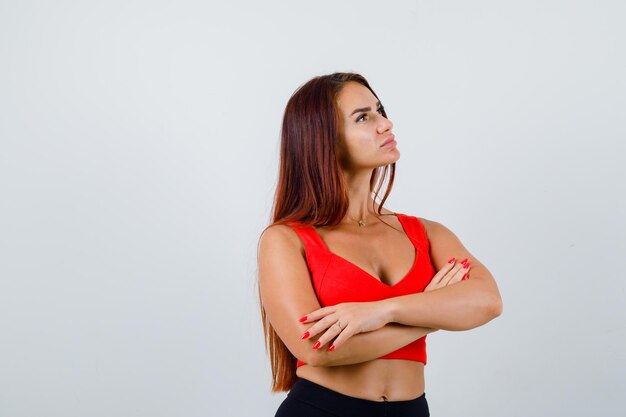 Young woman with long hair in an orange tank top