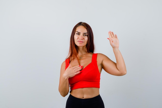 Young woman with long hair in an orange tank top