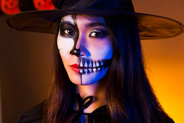 Young woman with makeup and scary mask