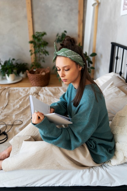 Young woman with messy bun working from home