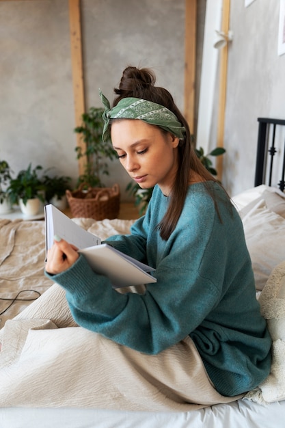 Young woman with messy bun working from home