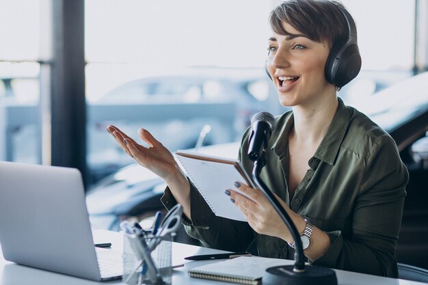 Young woman with microphone recording voice acting