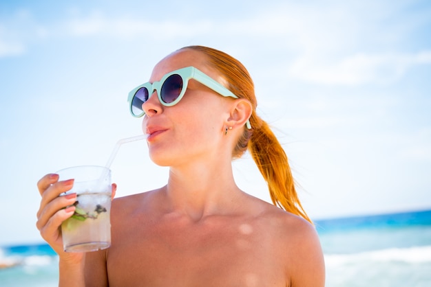 Young woman with mojito