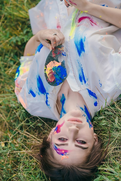 Free Photo young woman with paint on clothes and face