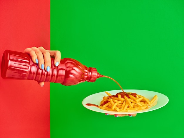 Young woman with plate of french fries potato with ketchup