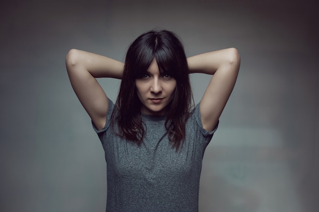 Young woman with shirt on wall