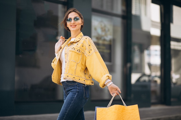 Young woman with shopping bags in the city