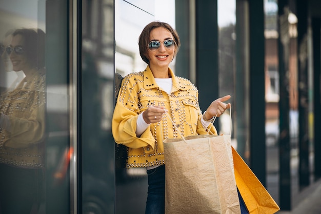 Free photo young woman with shopping bags in the city