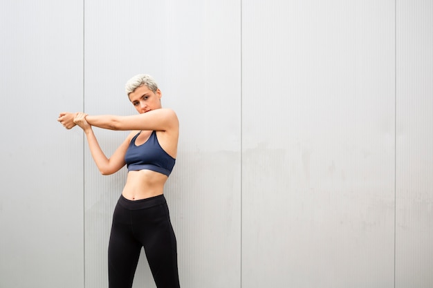 Young woman with short hair stretching