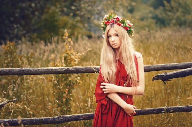 Young woman with straight hair wearing a red dress